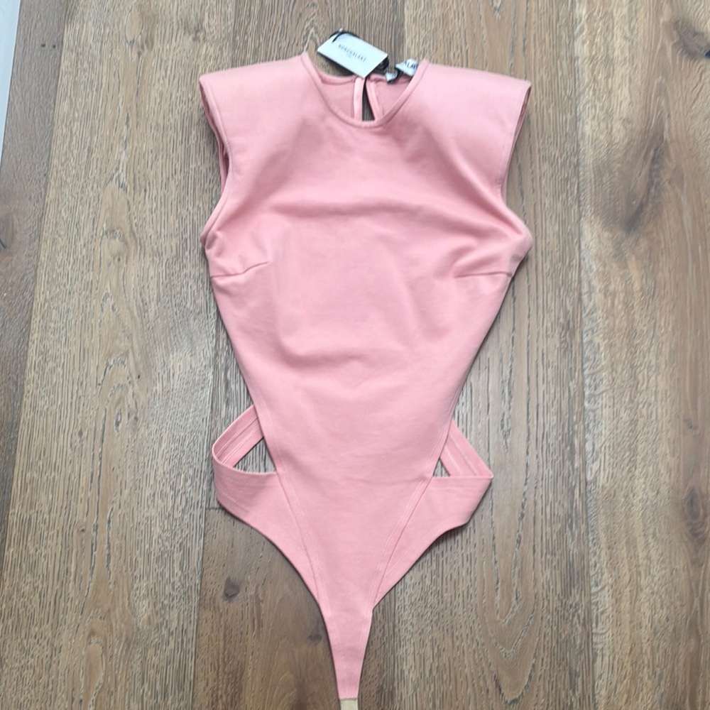 Nonchalant label body suit with cut outs at hips. Never worn new